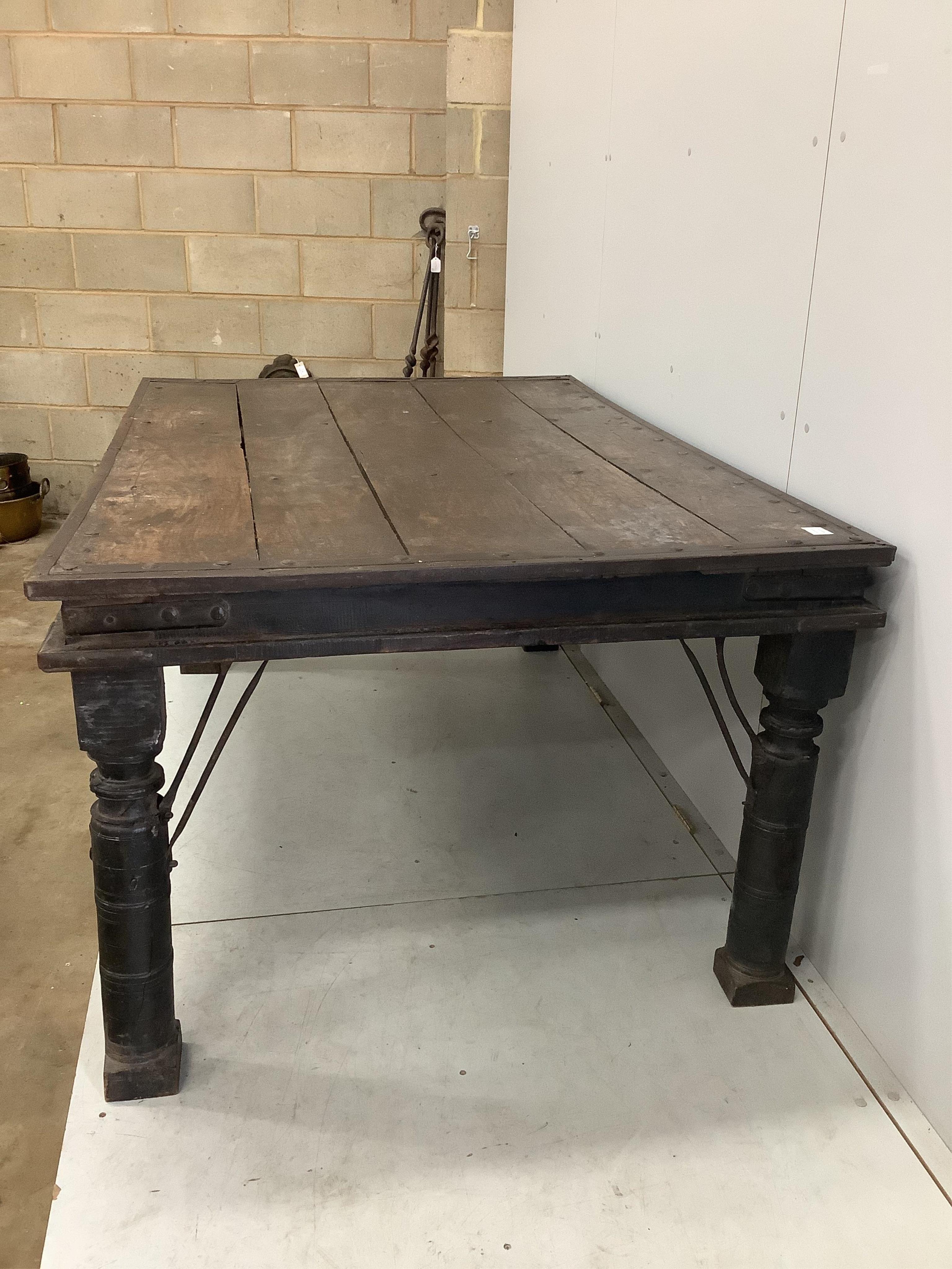 An Indian iron studded hardwood dining table, width 176cm, depth 116cm, height 78cm. Condition - fair